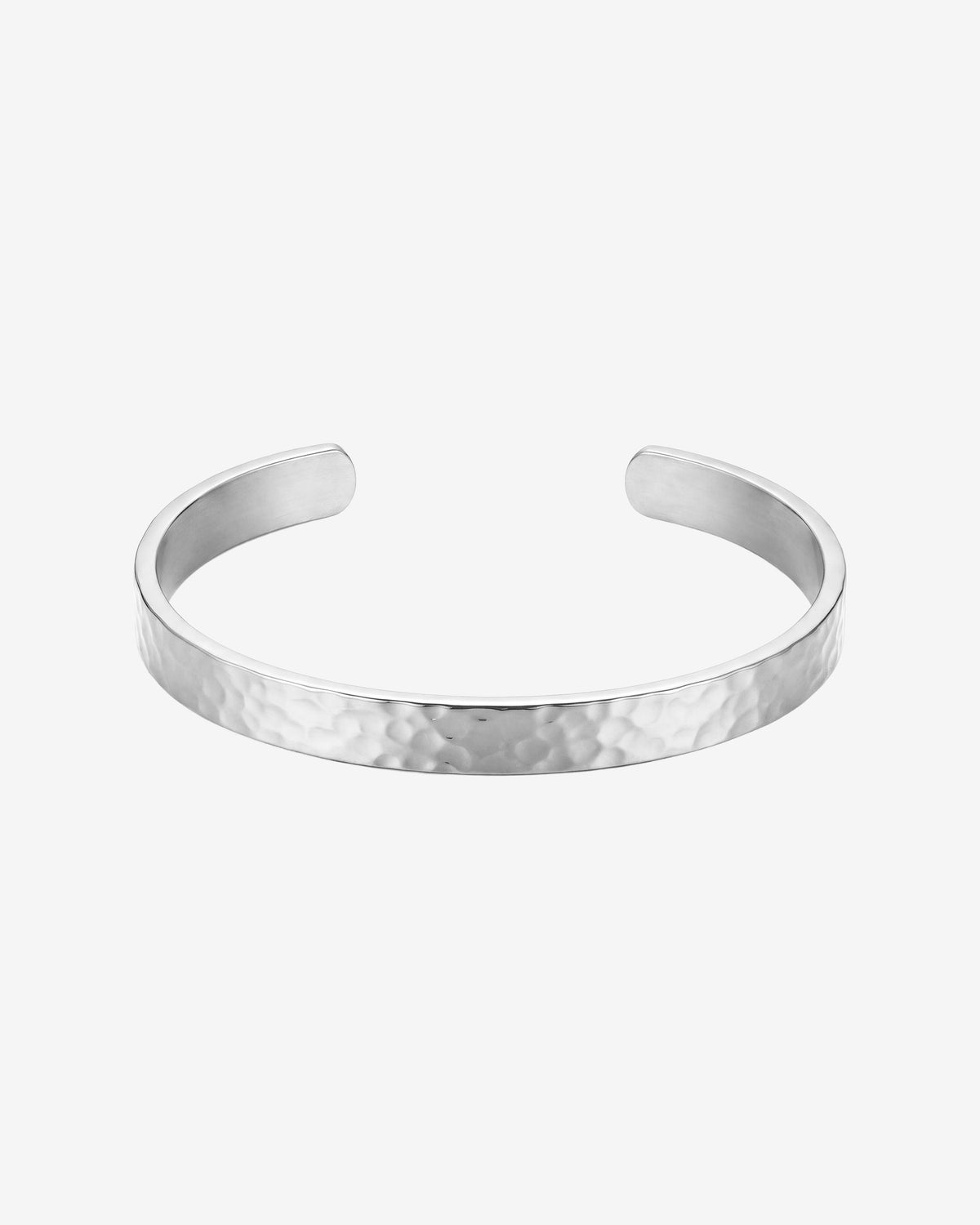 Hammered silver bracelet on a man's wrist with a textured band