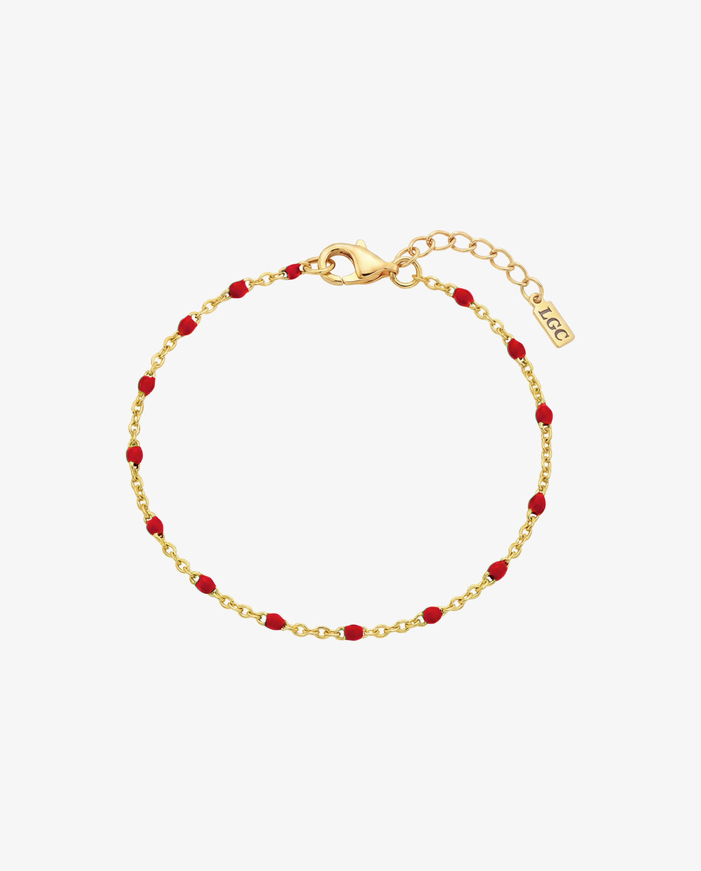 Gold bracelet with red beads and lobster clasp on the wrist