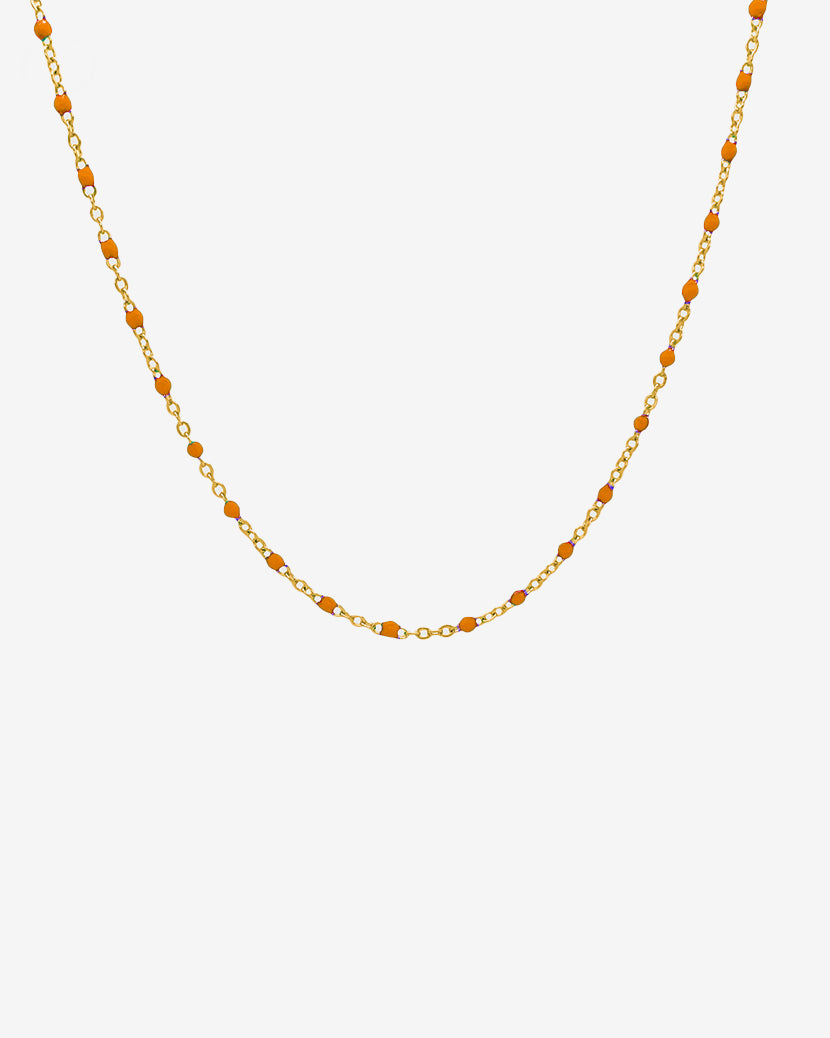 GEM gold chain necklace with orange beads spaced along a delicate gold link chain on white background