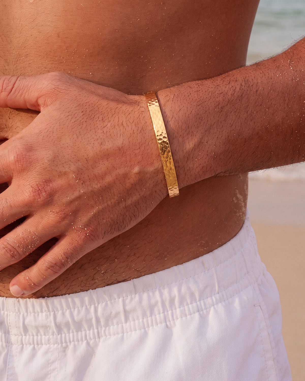 Hammered gold bracelet on a forearm