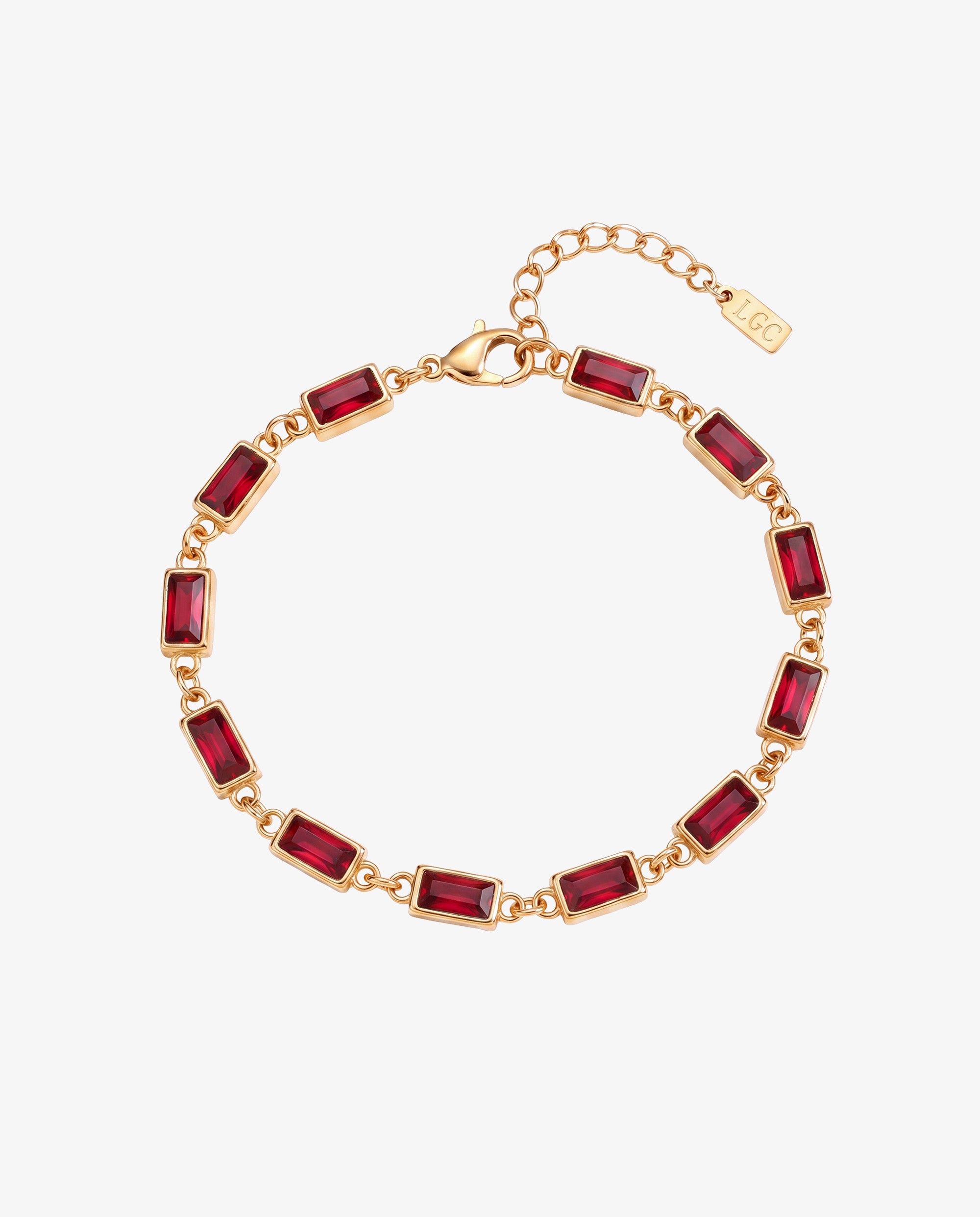 Gold bracelet with rectangular red stones arranged around a circular display on white background