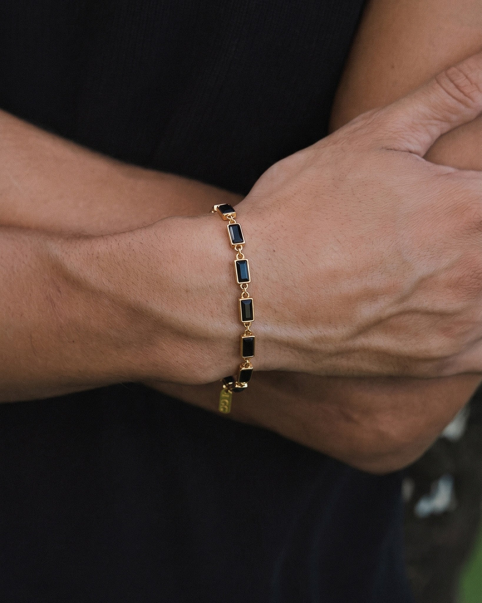 Omen Gold Bracelet with rectangular dark stones linked along the wrist