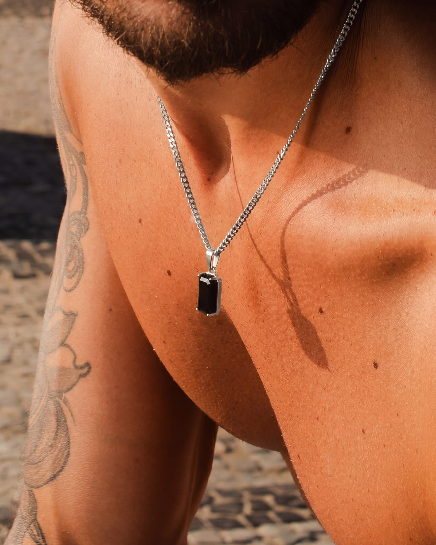 VOLT silver necklace with a tall black rectangular pendant on the chest